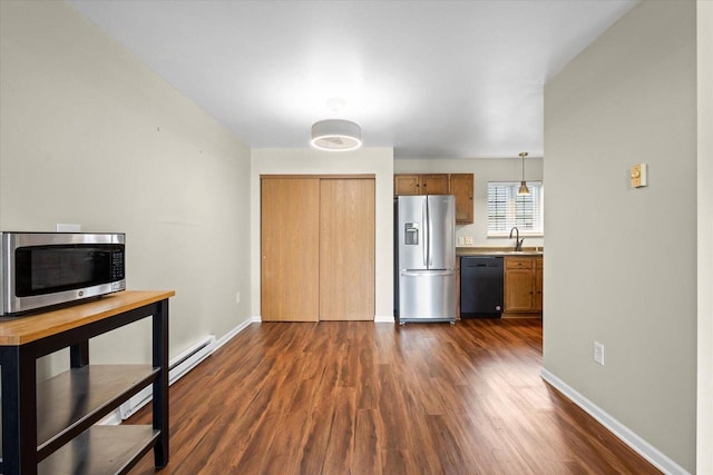 514 Root Ave Unit D, Hartford, WI 53027 - kitchen with stainless steel appliances, a baseboard heating unit, dark wood-style floors, and a sink