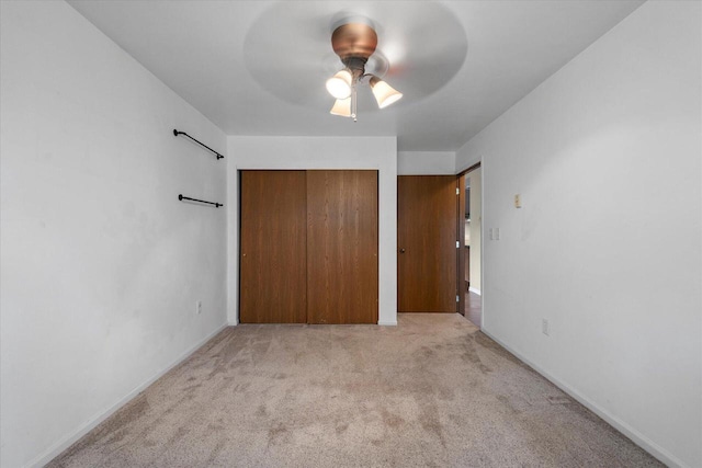 514 Root Ave Unit D, Hartford, WI 53027 - unfurnished bedroom featuring a closet, light carpet, and ceiling fan