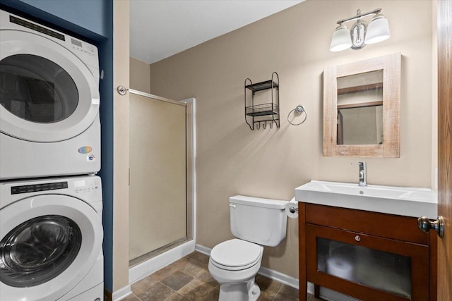 514 Root Ave Unit D, Hartford, WI 53027 - full bath with stacked washer / dryer, a stall shower, toilet, vanity, and baseboards