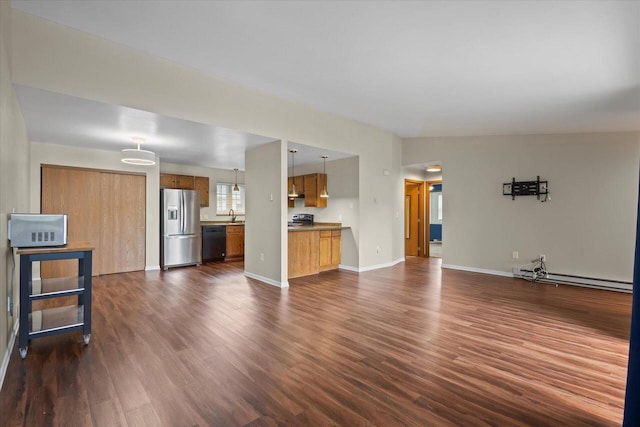 514 Root Ave Unit D, Hartford, WI 53027 - unfurnished living room featuring baseboard heating, dark wood-style floors, a sink, and baseboards