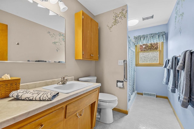 904 S Hamlin St, Shawano, WI 54166 - bathroom featuring toilet, vanity, a stall shower, and baseboards