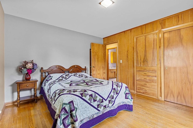 904 S Hamlin St, Shawano, WI 54166 - bedroom featuring light wood-style flooring, wood walls, and baseboards