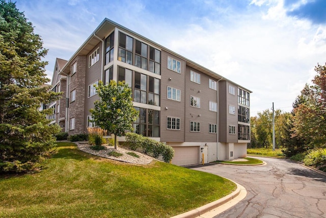 211 Oconomowoc Pkwy, Oconomowoc, WI 53066 - view of apartment building / complex with asphalt driveway and a garage