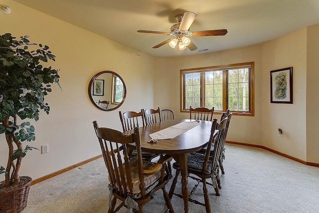 211 Oconomowoc Pkwy, Oconomowoc, WI 53066 - dining space featuring light carpet, baseboards, and a ceiling fan
