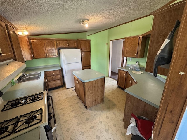 S7559 US Highway 12 Unit M-8, North Freedom, WI 53951 - kitchen featuring white appliances, a sink, light flooring, a center island, and a textured ceiling