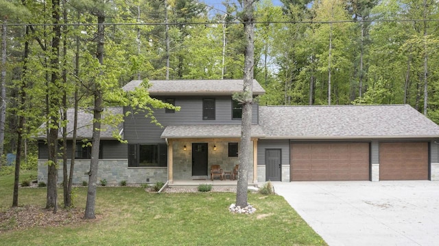 W2434 Timber Trl, Keshena, WI 54135 - view of front facade featuring an attached garage, covered porch, stone siding, driveway, and a front yard