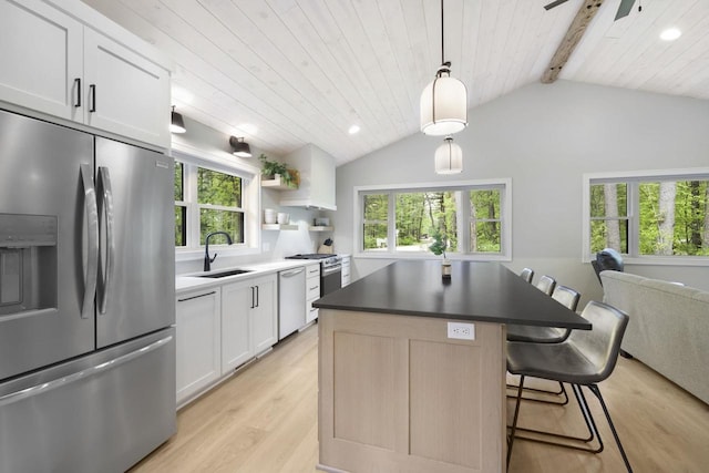 W2434 Timber Trl, Keshena, WI 54135 - kitchen with stainless steel refrigerator with ice dispenser, dishwasher, a sink, light wood-style floors, and a kitchen island
