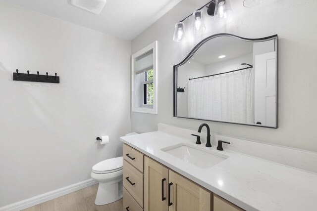 W2434 Timber Trl, Keshena, WI 54135 - full bathroom featuring vanity, wood finished floors, toilet, and baseboards