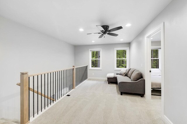 W2434 Timber Trl, Keshena, WI 54135 - living area with carpet, an upstairs landing, recessed lighting, ceiling fan, and baseboards
