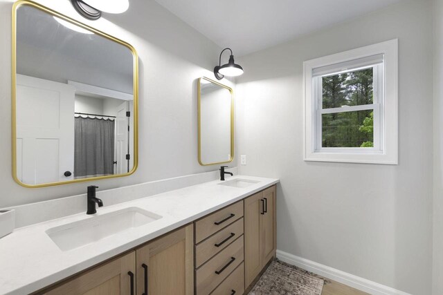 W2434 Timber Trl, Keshena, WI 54135 - bathroom featuring double vanity and baseboards