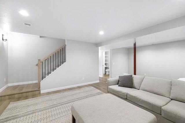 W2434 Timber Trl, Keshena, WI 54135 - living area featuring baseboards, wood finished floors, stairway, and recessed lighting