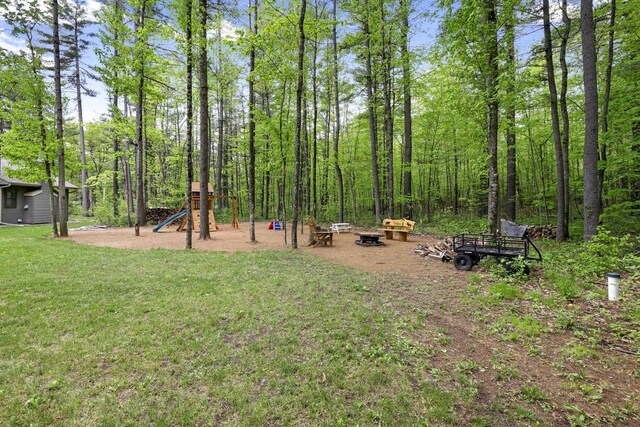 W2434 Timber Trl, Keshena, WI 54135 - view of green lawn with a playground and an outdoor fire pit