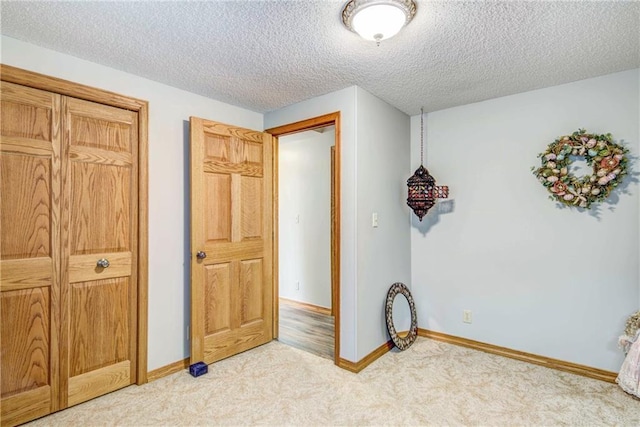 E5777 689th Ave, Menomonie, WI 54751 - unfurnished bedroom with light carpet, a textured ceiling, and baseboards