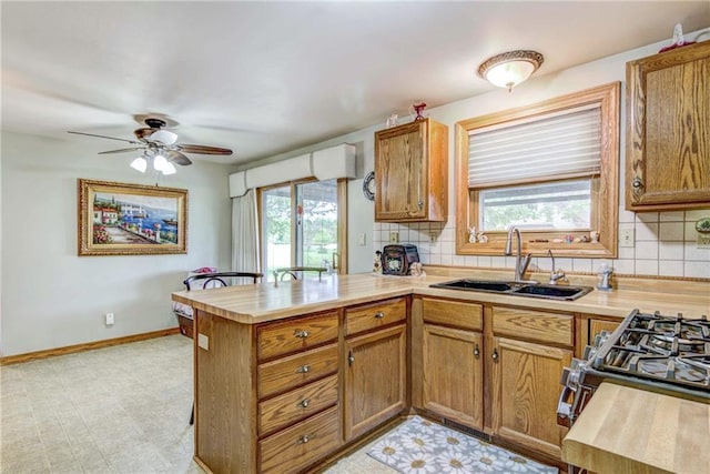 E5777 689th Ave, Menomonie, WI 54751 - kitchen with a sink, a peninsula, healthy amount of natural light, and light countertops