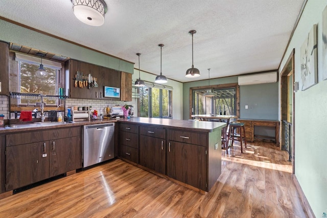 3910 E Koenig Rd, Superior, WI 54880 - kitchen with dishwasher, a sink, a textured ceiling, dark countertops, and light wood finished floors