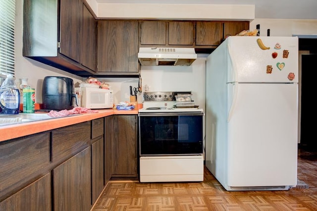 129 Luby Ave, Oconto, WI 54153 - kitchen featuring white appliances, under cabinet range hood, light countertops, and dark brown cabinets