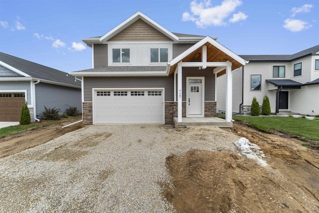 727 Schubert St, Verona, WI 53593 - craftsman-style house with gravel driveway, stone siding, and an attached garage
