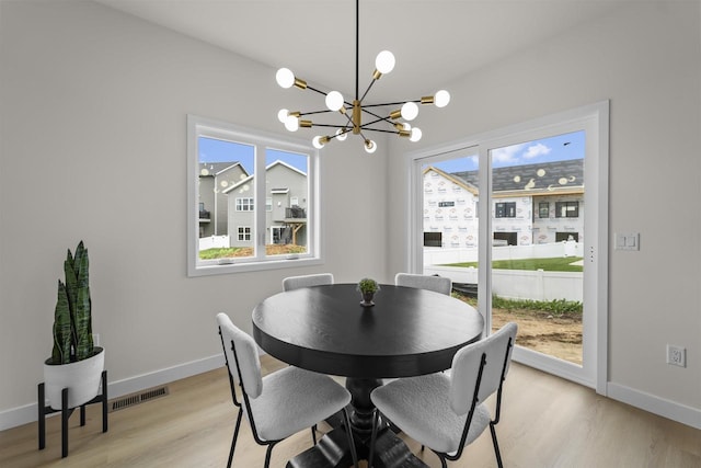 727 Schubert St, Verona, WI 53593 - dining space featuring a chandelier, light wood-type flooring, and baseboards