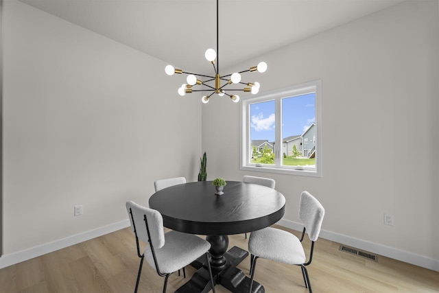 727 Schubert St, Verona, WI 53593 - dining room with light wood-style floors, baseboards, and a chandelier