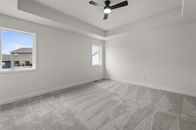 727 Schubert St, Verona, WI 53593 - empty room with a tray ceiling, baseboards, carpet flooring, and ceiling fan