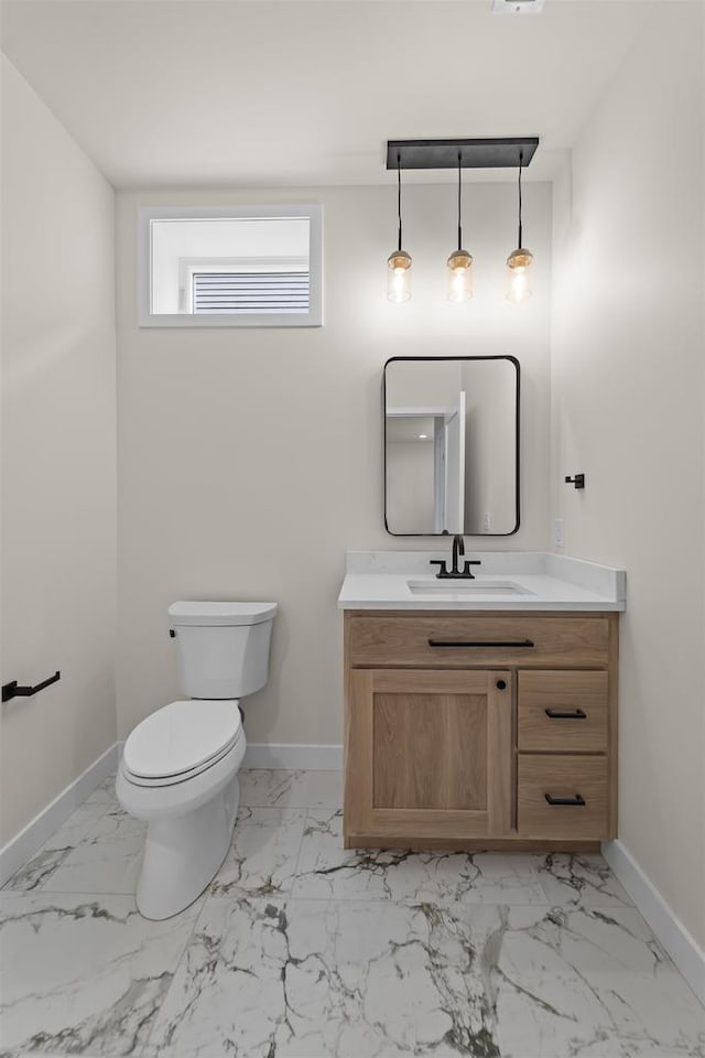 727 Schubert St, Verona, WI 53593 - half bathroom with baseboards, vanity, marble look tiles, and toilet