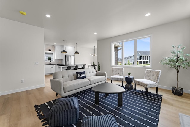 727 Schubert St, Verona, WI 53593 - living room with light wood-type flooring, baseboards, and recessed lighting