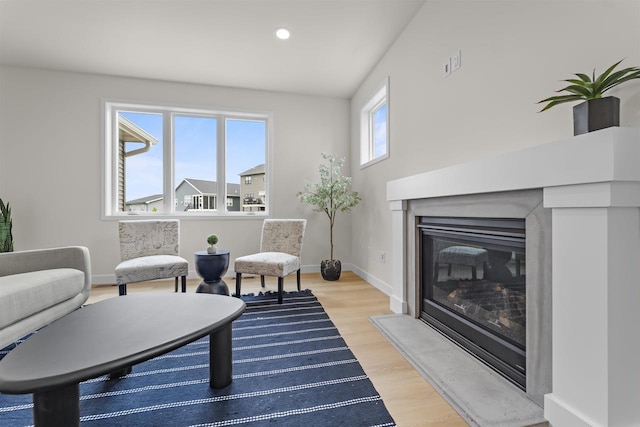 727 Schubert St, Verona, WI 53593 - living room featuring light wood-style flooring, a glass covered fireplace, baseboards, and recessed lighting