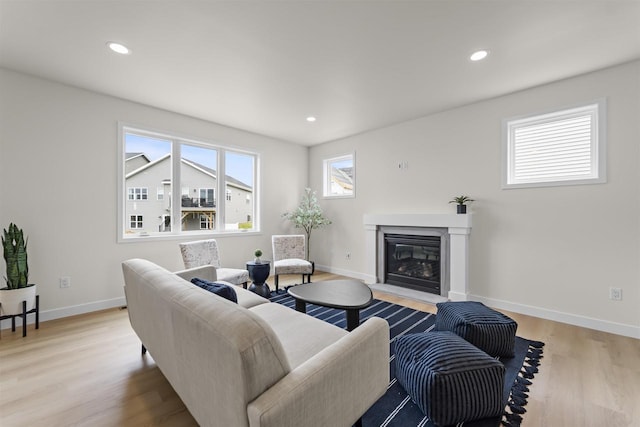 727 Schubert St, Verona, WI 53593 - living area featuring a glass covered fireplace, light wood finished floors, baseboards, and recessed lighting