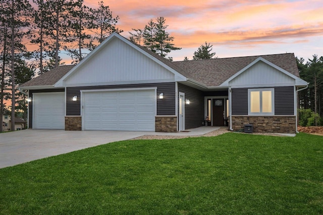 807 W Saddle Rdg Unit 807, Portage, WI 53901 - view of front of home featuring a garage, concrete driveway, stone siding, and a shingled roof