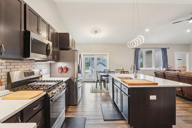 807 W Saddle Rdg Unit 807, Portage, WI 53901 - kitchen with appliances with stainless steel finishes, a sink, dark brown cabinetry, open floor plan, and light countertops