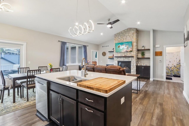 807 W Saddle Rdg Unit 807, Portage, WI 53901 - kitchen featuring a sink, stainless steel dishwasher, a stone fireplace, dark wood-style flooring, and light countertops