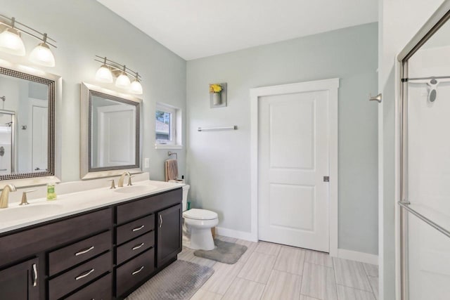 807 W Saddle Rdg Unit 807, Portage, WI 53901 - full bathroom with a stall shower, double vanity, toilet, and baseboards