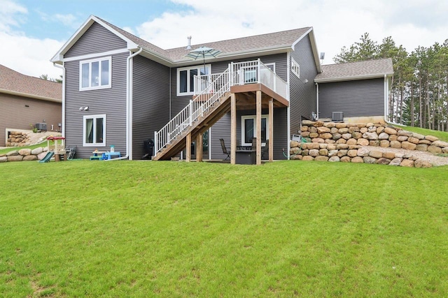 807 W Saddle Rdg Unit 807, Portage, WI 53901 - rear view of house with stairs, a wooden deck, a yard, and a shingled roof