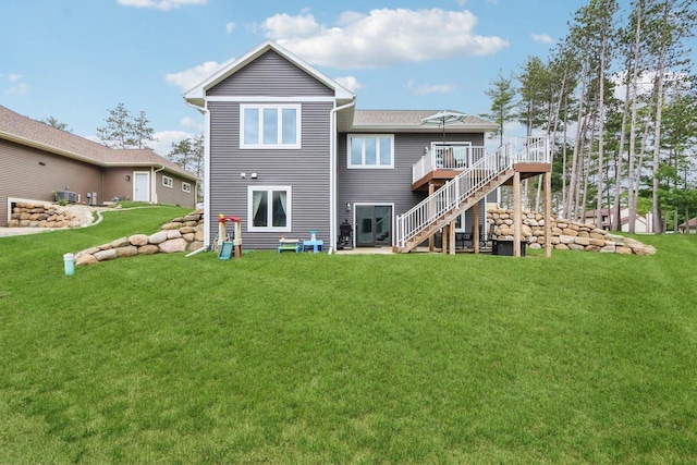 807 W Saddle Rdg Unit 807, Portage, WI 53901 - rear view of property with stairs, a wooden deck, and a yard