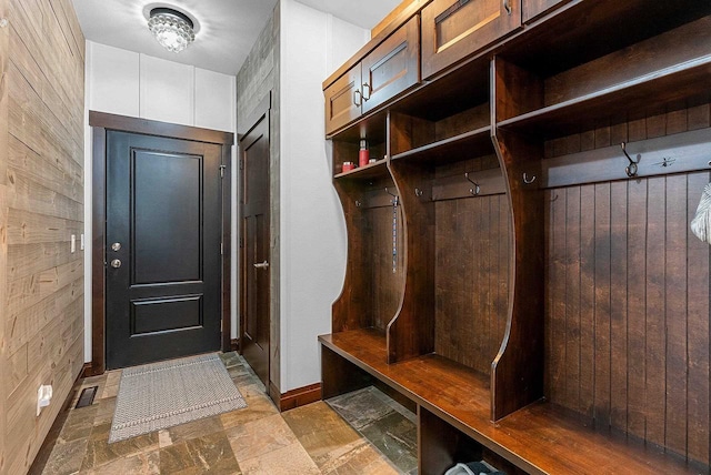 E12603 Bay Rd, Merrimac, WI 53561 - mudroom featuring wooden walls, stone finish floors, and baseboards