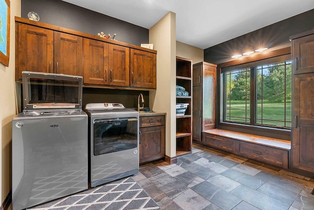 E12603 Bay Rd, Merrimac, WI 53561 - washroom featuring cabinet space, washer and clothes dryer, and dark stone finish flooring