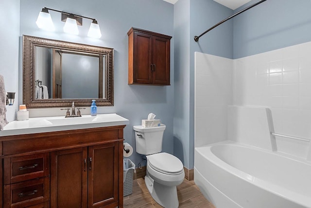 E12603 Bay Rd, Merrimac, WI 53561 - full bath featuring toilet, vanity, bathing tub / shower combination, wood finished floors, and baseboards