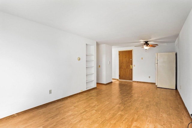 1923 Sherman Ave, Madison, WI 53704 - spare room featuring ceiling fan, built in features, light wood-style flooring, and baseboards