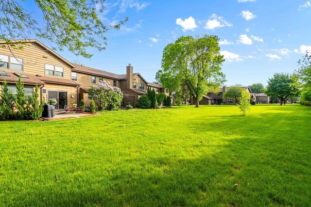 1115 Daniel Ct Unit 40, Neenah, WI 54956 - view of grassy yard featuring a patio