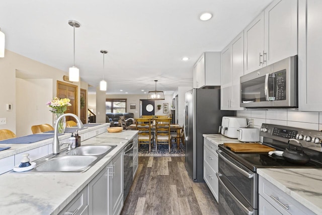 1115 Daniel Ct Unit 40, Neenah, WI 54956 - kitchen with stainless steel appliances, a sink, dark wood-style floors, recessed lighting, and pendant lighting