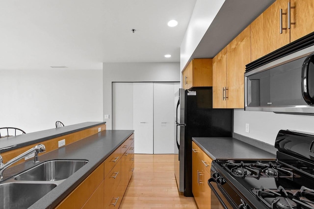 101 Cherry St Unit 208, Green Bay, WI 54301 - kitchen featuring gas stove, stainless steel microwave, a sink, dark countertops, and recessed lighting