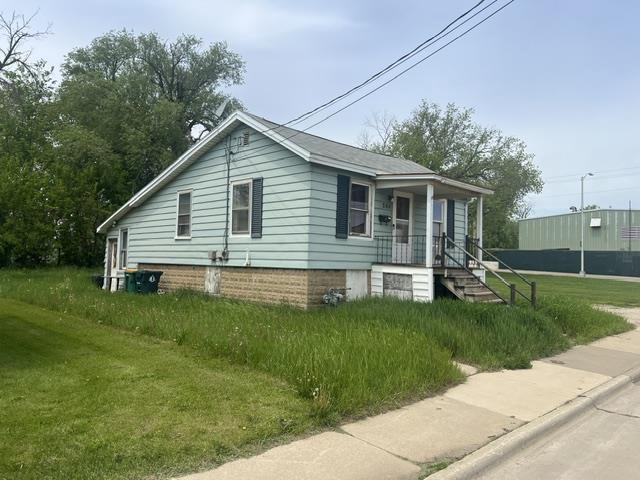 244 Satterlee St, Fond Du Lac, WI 54935 - view of side of home featuring covered porch and a lawn