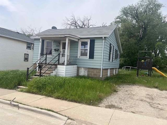 244 Satterlee St, Fond Du Lac, WI 54935 - view of front of property featuring a playground, roof with shingles, and covered porch