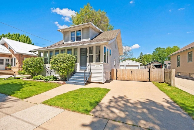 816 W Oklahoma St, Appleton, WI 54914 - bungalow-style home with a gate, concrete driveway, and a shingled roof