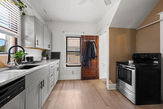 816 W Oklahoma St, Appleton, WI 54914 - kitchen with appliances with stainless steel finishes, a sink, baseboards, light wood finished floors, and light countertops