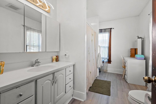 816 W Oklahoma St, Appleton, WI 54914 - full bathroom with wood finished floors, plenty of natural light, vanity, and baseboards