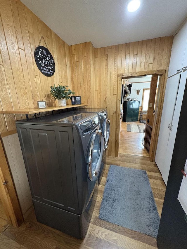 114 E Freeborn St, Cecil, WI 54111 - laundry area featuring wood walls, independent washer and dryer, and light wood-type flooring