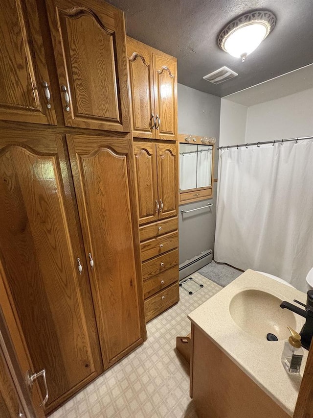 114 E Freeborn St, Cecil, WI 54111 - bathroom featuring tile patterned floors, vanity, a baseboard heating unit, and curtained shower