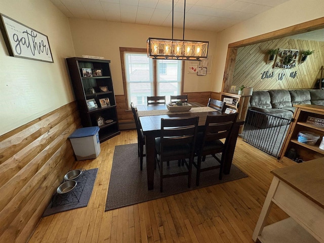 114 E Freeborn St, Cecil, WI 54111 - dining area featuring a wainscoted wall, hardwood / wood-style floors, and a chandelier