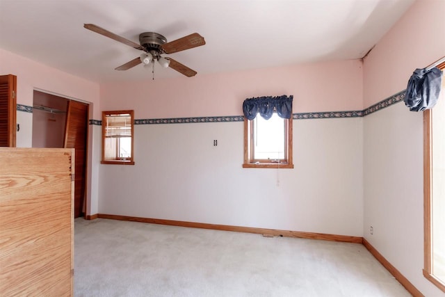 302 W Division St, Fond Du Lac, WI 54935 - unfurnished bedroom with light colored carpet, baseboards, and a ceiling fan